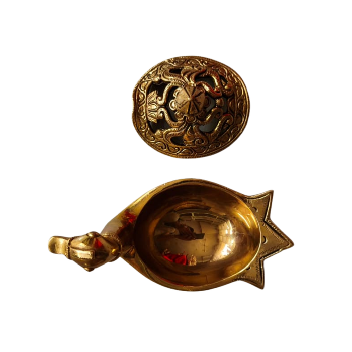 Intricate handcrafted brass peacock artifact with engraved lid, a decorative brass art piece.