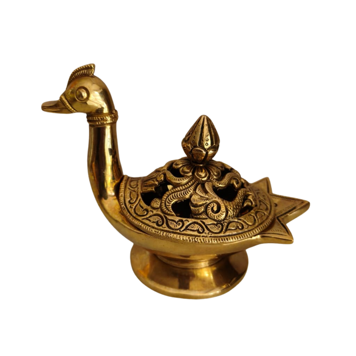 Decorative brass peacock artifact with engraved lid, intricate metalwork.