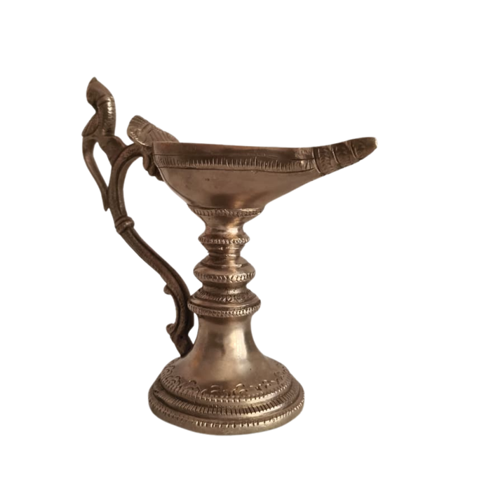 Handcrafted hanging peacock diya, a traditional brass oil lamp.