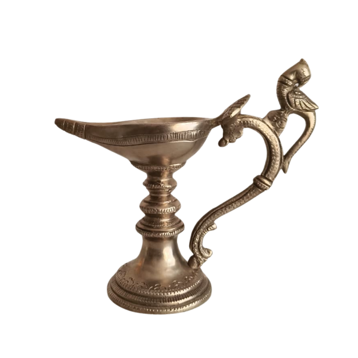 Handcrafted hanging peacock diya oil lamp made of brass, a beautiful traditional decoration.