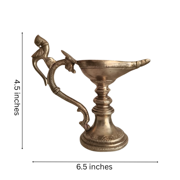 Handcrafted hanging peacock diya, a brass oil lamp.