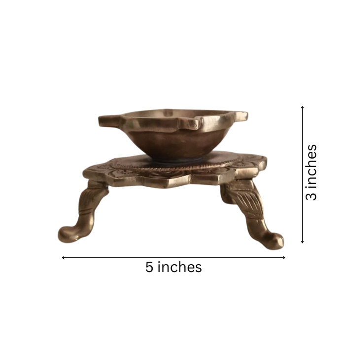 Handcrafted brass lotus diya with ornate legs, a traditional tabletop oil lamp.