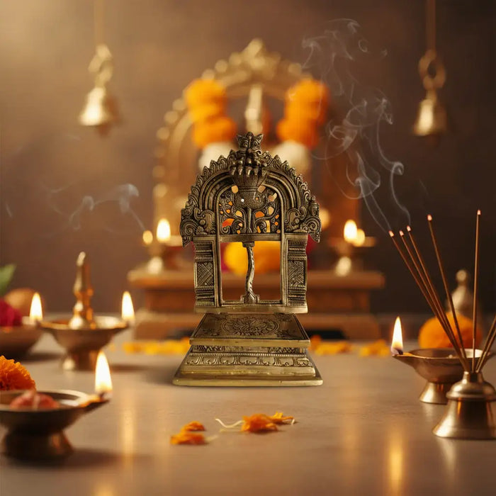 Intricately carved brass prabhavali for pooja, a decorative brass arch.