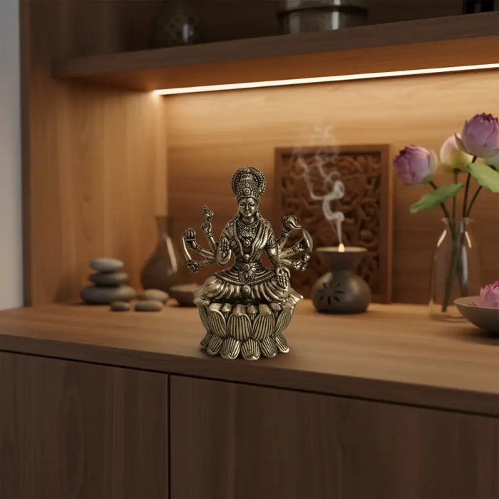 Brass Mahalakshmi eight arms idol seated on lotus. Religious brass idol.
