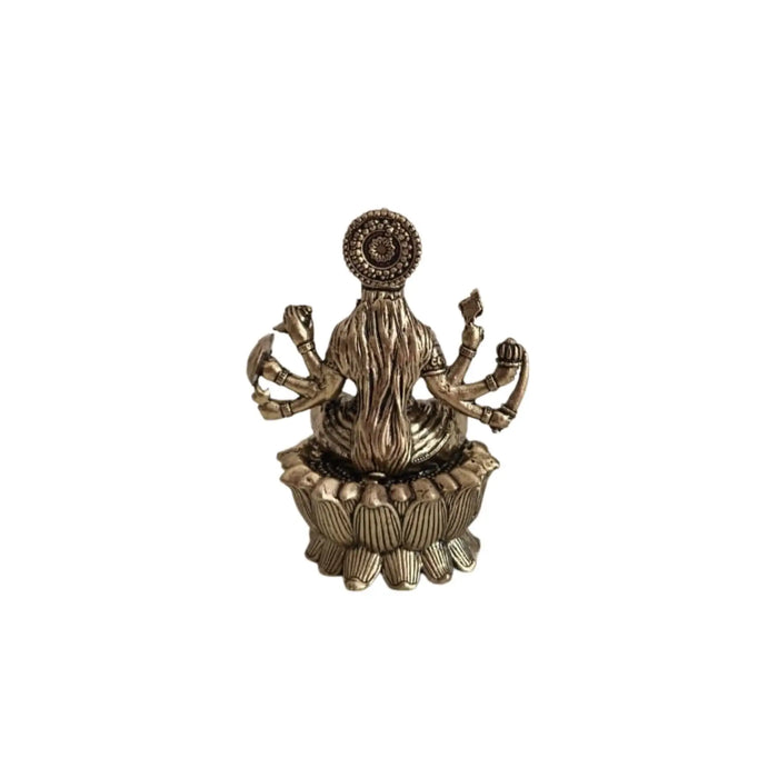 Brass Mahalakshmi eight arms idol seated on a lotus base, a religious sculpture.