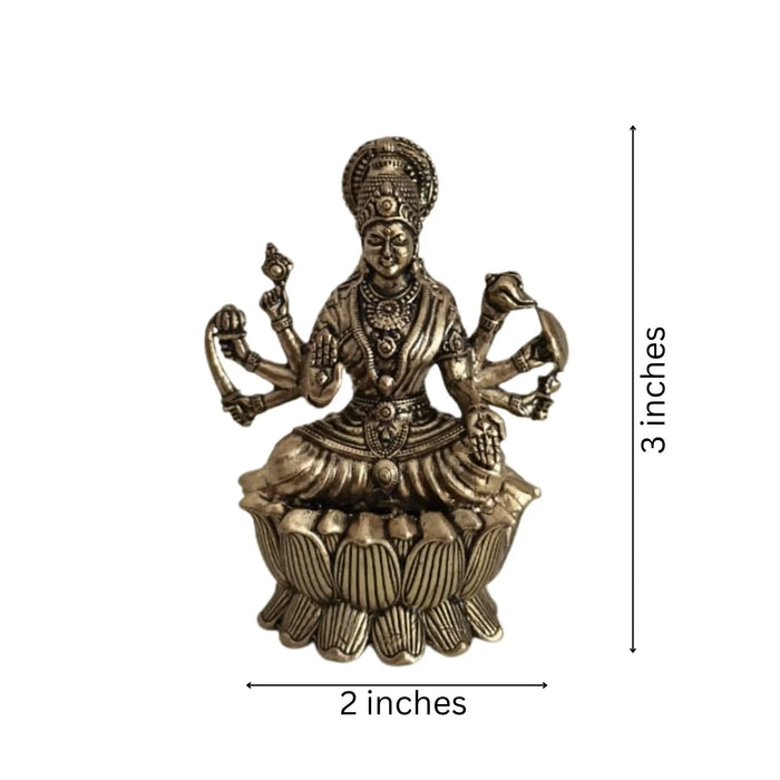 Brass Mahalakshmi eight arms idol seated on lotus base.