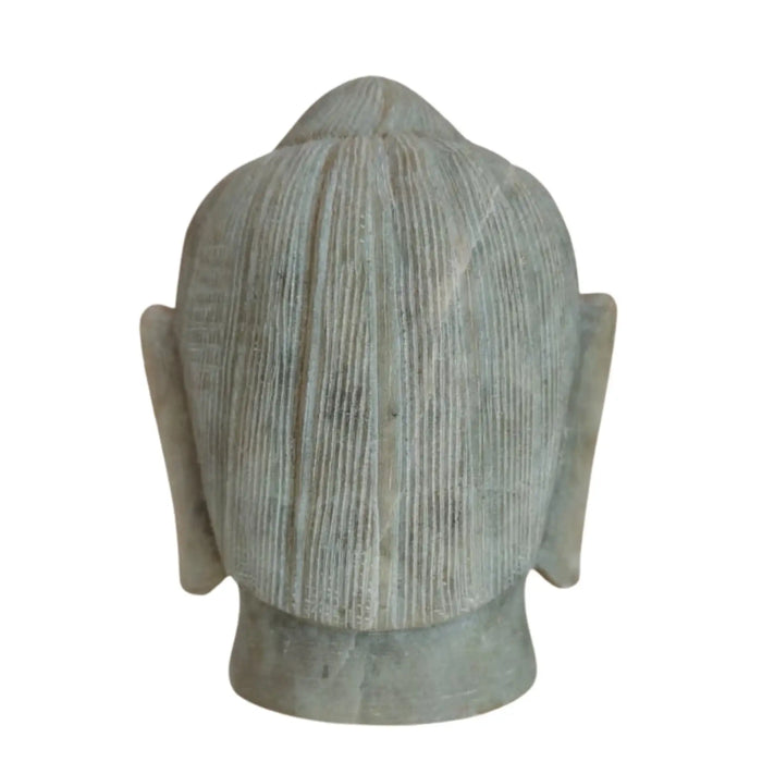 White marble Buddha face statue for meditation and home décor.