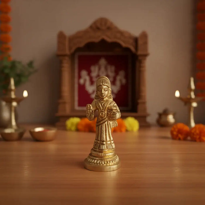 Miniature Goddess Annapoorna Idol in gleaming brass, a symbol of nourishment.