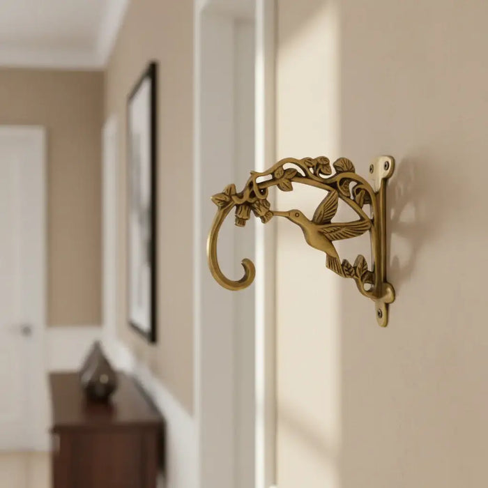 Ornate antique brass wall bracket for hanging decor.
