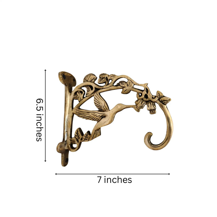 Ornate antique brass wall bracket for hanging decor.