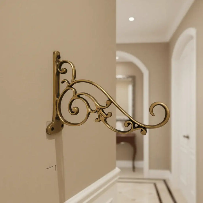 Ornate antique brass wall bracket for hanging items.