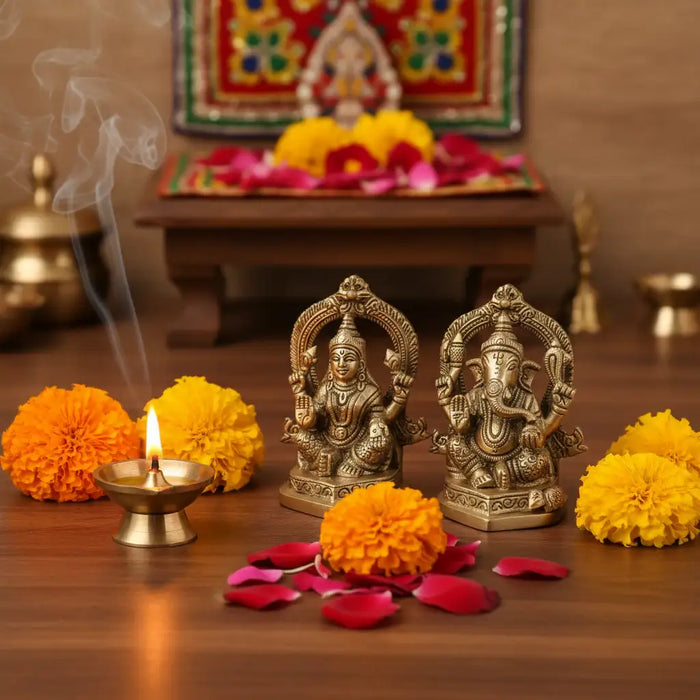 Ornate brass Ganesha and Lakshmi idols in a divine pairing, showcasing intricate detail.