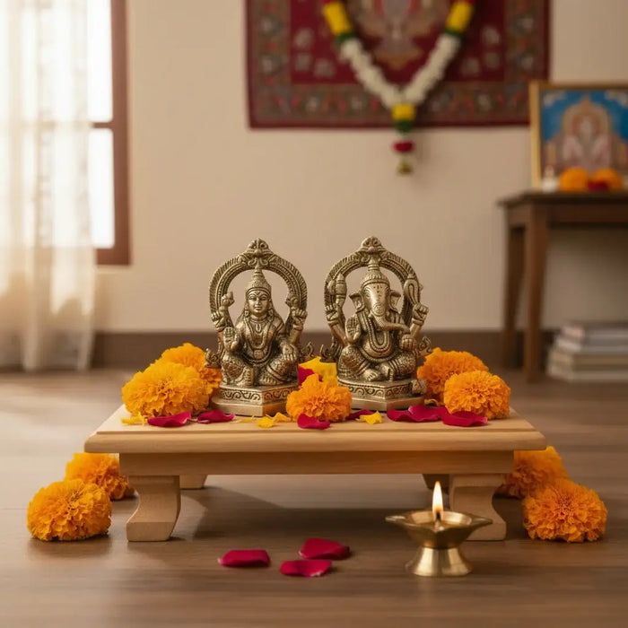 Ornate brass Ganesha and Lakshmi idols, showcasing intricate details and craftsmanship.