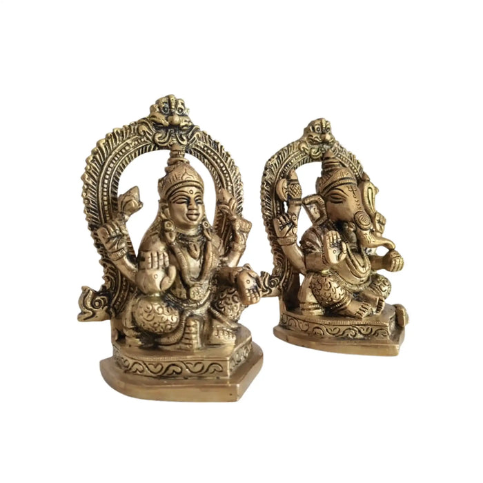 Ornate brass Ganesha and Lakshmi idols, representing prosperity and wisdom.