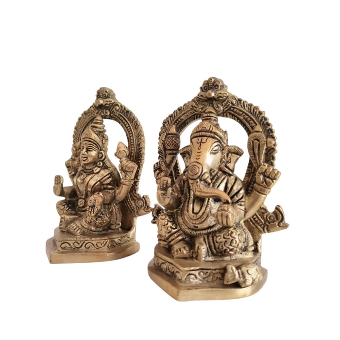 Ornate brass Ganesha and Lakshmi idols, detailed brass ware statues.