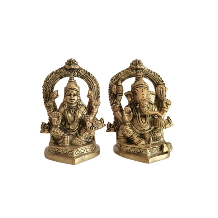 Ornate brass Ganesha and Lakshmi idols, detailed Hindu deities for worship.