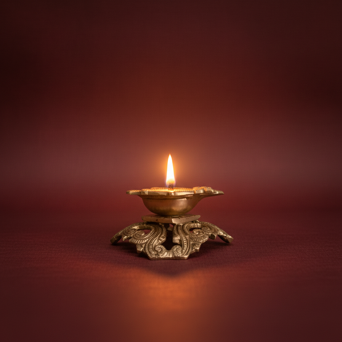 Ornate pedestal diya, a handcrafted brass oil lamp, beautifully decorated.