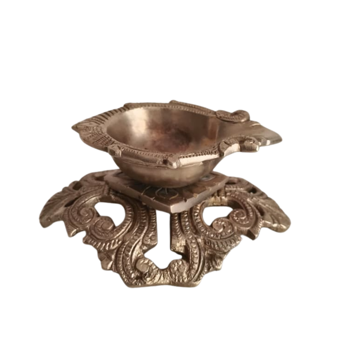 Ornate pedestal diya, a handcrafted traditional brass oil lamp.
