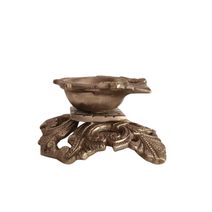 Ornate pedestal diya brass oil lamp, handcrafted traditional decorative.