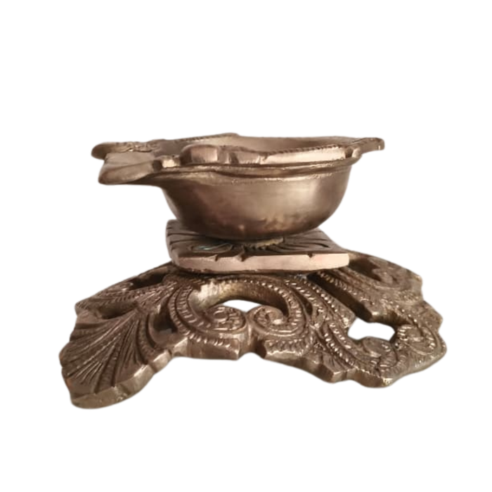 Ornate pedestal diya brass oil lamp, handcrafted traditional decorative.