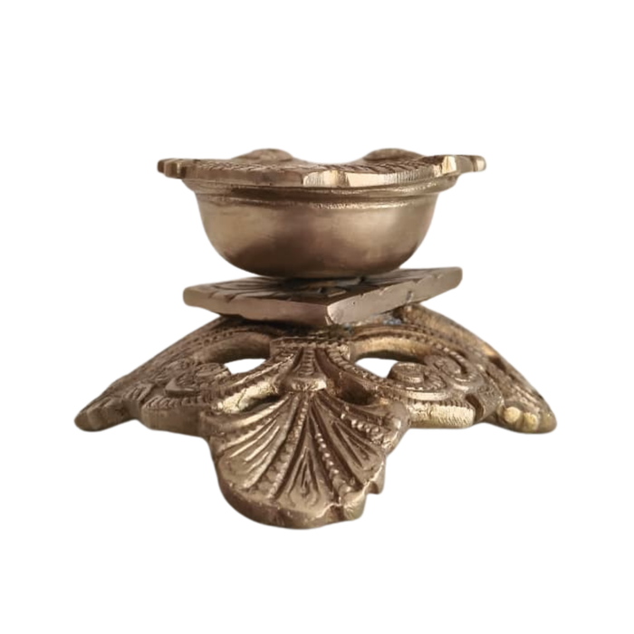 Ornate pedestal diya, handcrafted brass oil lamp, traditional decorative lighting.