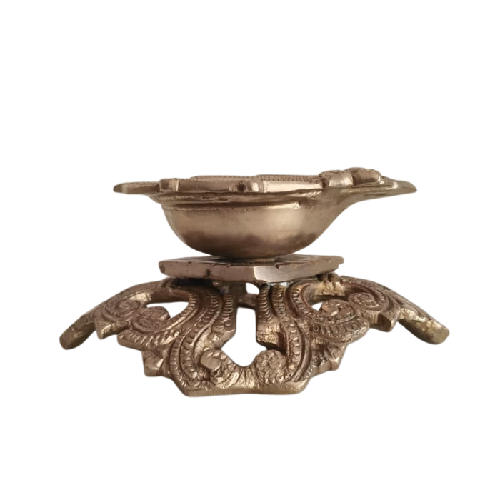 Ornate pedestal diya, a handcrafted traditional brass oil lamp, decorative and detailed.