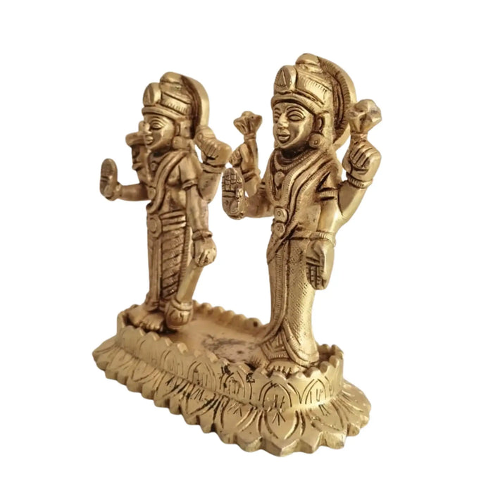 Sacred brass Vishnu Lakshmi idol seated on a lotus, symbolizing divine prosperity.