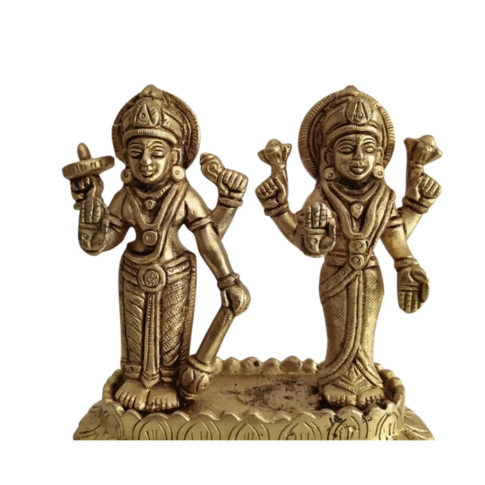 Sacred brass Vishnu Lakshmi idol on lotus, a symbol of divine prosperity.