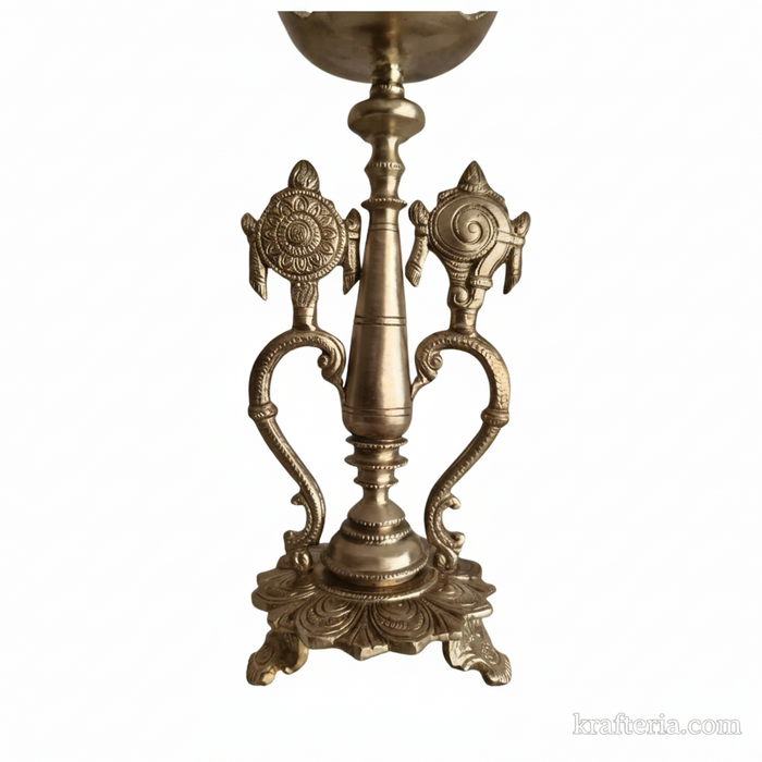 Sacred brass Vishnu lamp with shankh and chakra on pedestal. Brass altar diya.