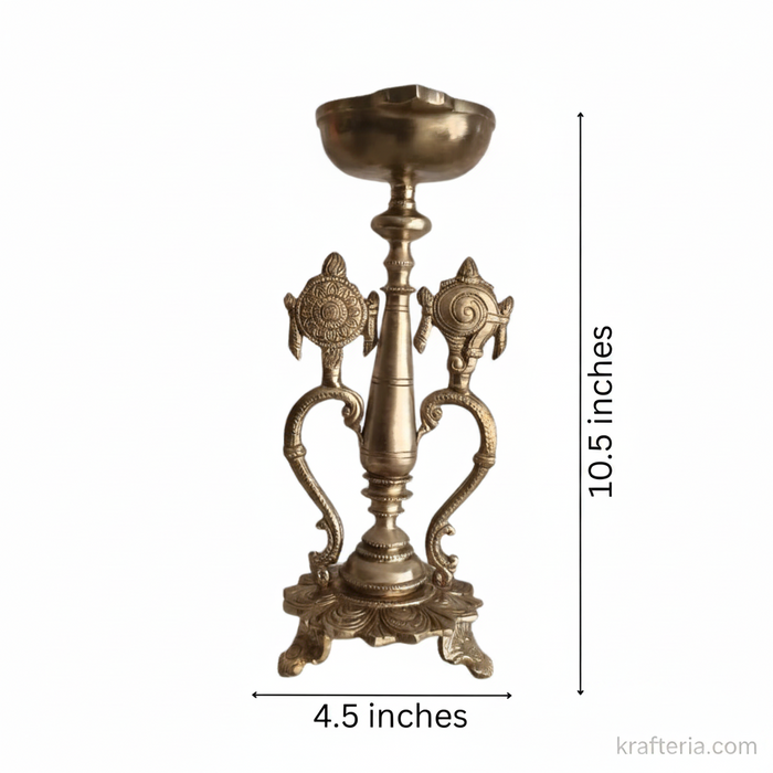 Sacred brass Vishnu lamp with shankh and chakra design, a beautiful altar diya.