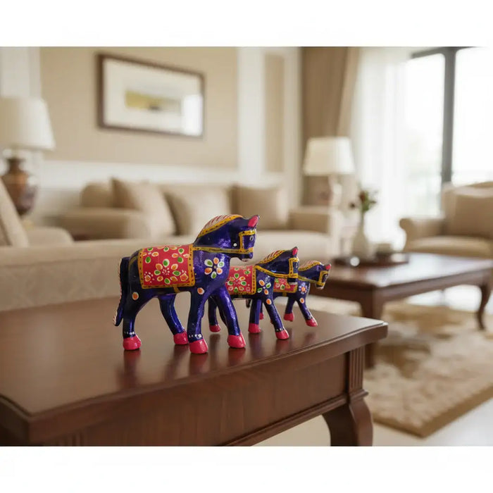 Set of 3 hand-painted wooden horses in royal blue and pink with traditional Indian folk art detailing