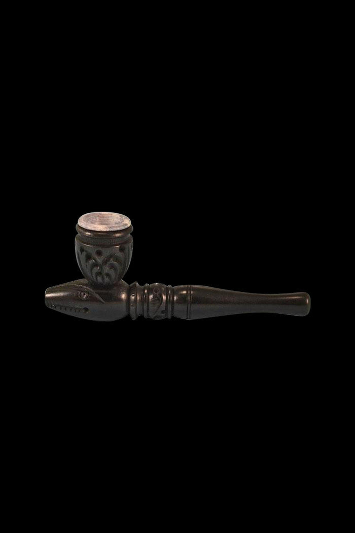 A side view of the Carved Wood Tobacco Pipe shows its dark, detailed wooden construction and curved bowl.