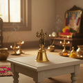 Brass temple bell with Vishnu handle, perfect for home decor.