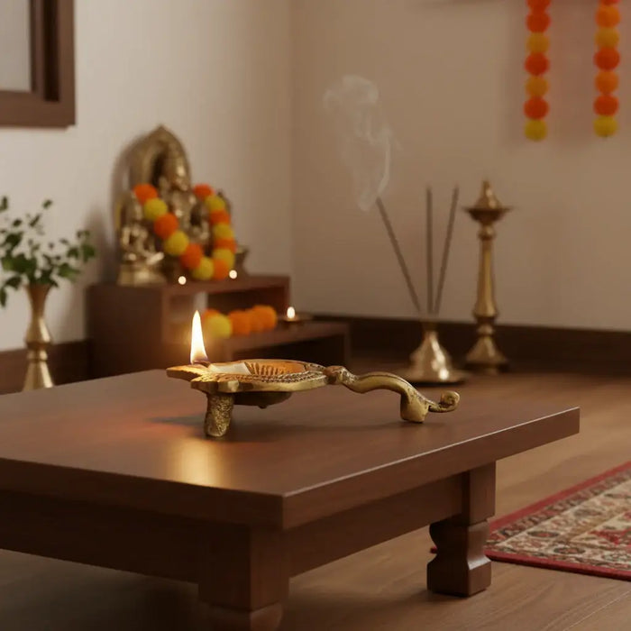 Traditional Brass Aarti Diya with Om symbol and handle.