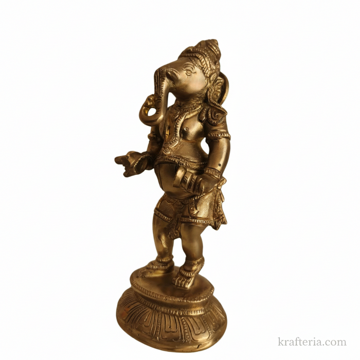 Traditional brass Ganesha cymbals idol on altar.
