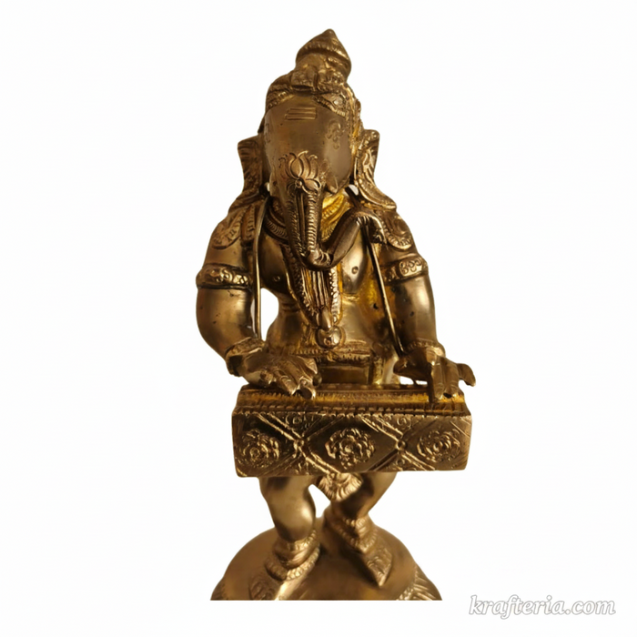 Lord Ganesha harmonium idol, a brass altar statue of the deity playing the instrument.