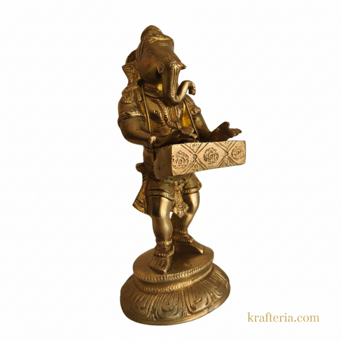Lord Ganesha harmonium idol, a traditional brass altar statue of the deity playing a musical instrument.